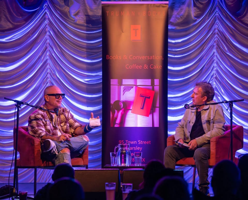 Nick Johnson hosting an on-stage author interview at Truman Books
