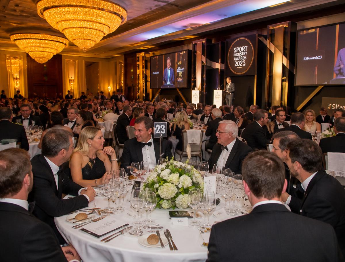 Guests applauding at a sporting dinner